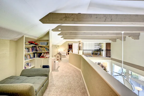a living room with furniture and a floor to ceiling window