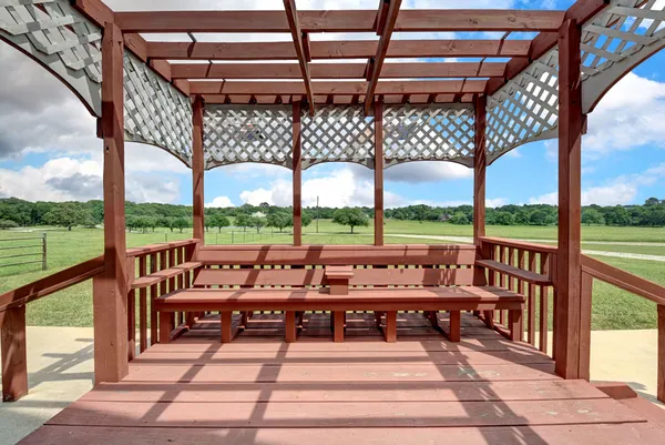 a view of a balcony with wooden floor and outdoor seating