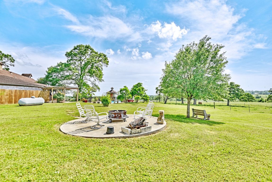 2575 Old Mill Creek Road Brenham, TX 77833 - Photo 29 of 40 a view of a swimming pool with a table and chairs