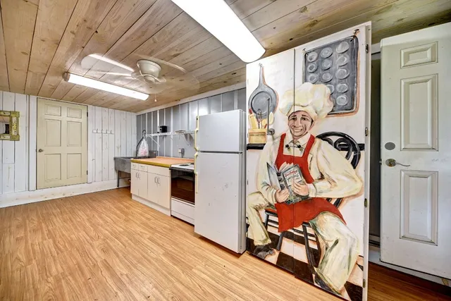 a kitchen with stainless steel appliances granite countertop a refrigerator and a stove