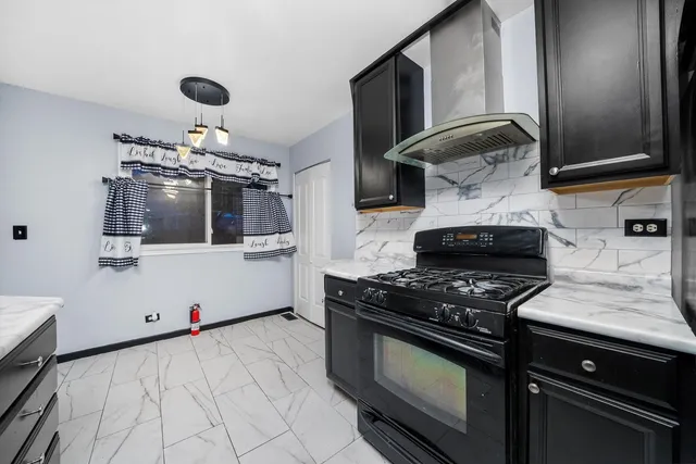 a kitchen with stainless steel appliances granite countertop a stove and a microwave