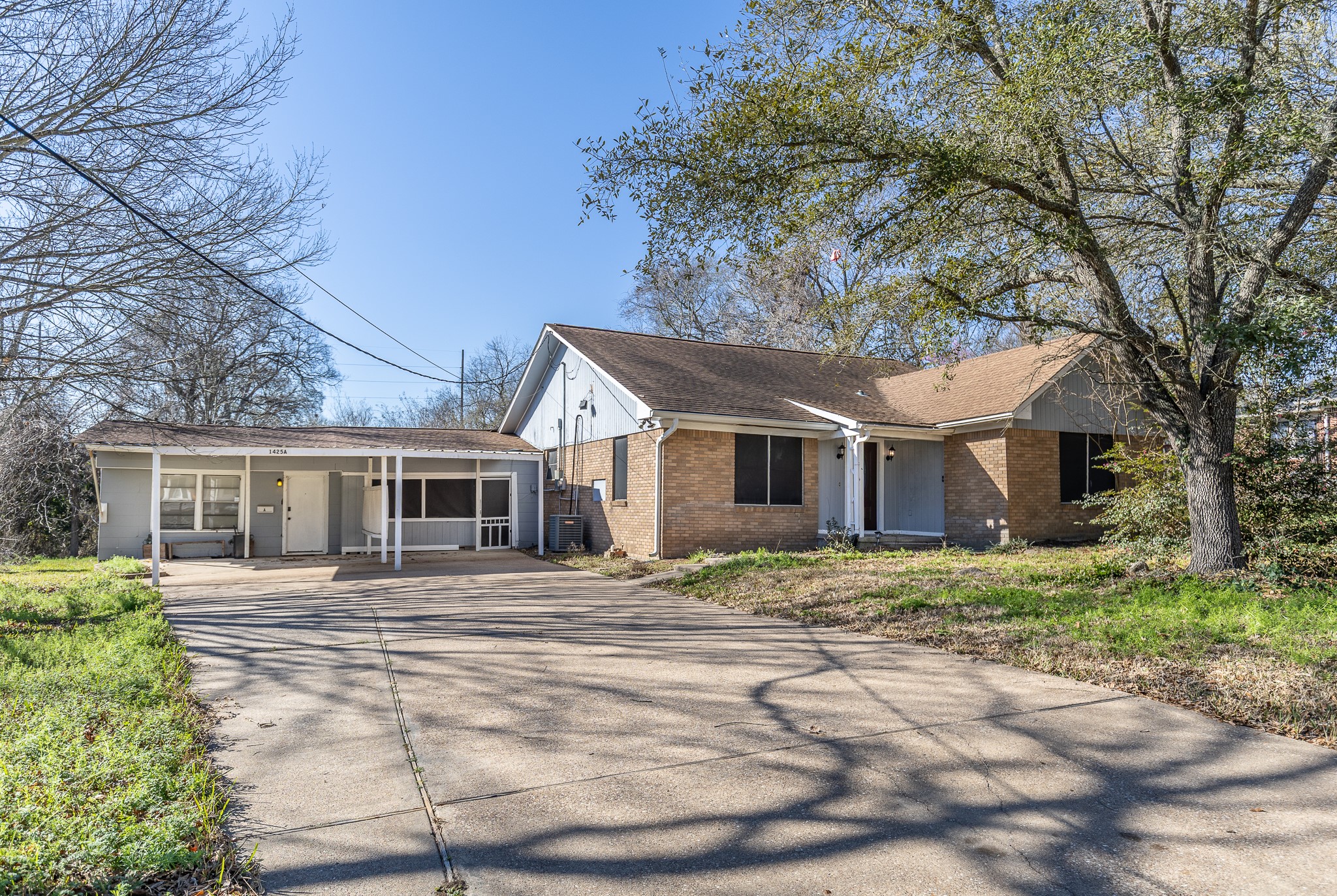 1425 15th Street Huntsville, TX 77340 - Photo 1 of 50 a front view of a house with a yard