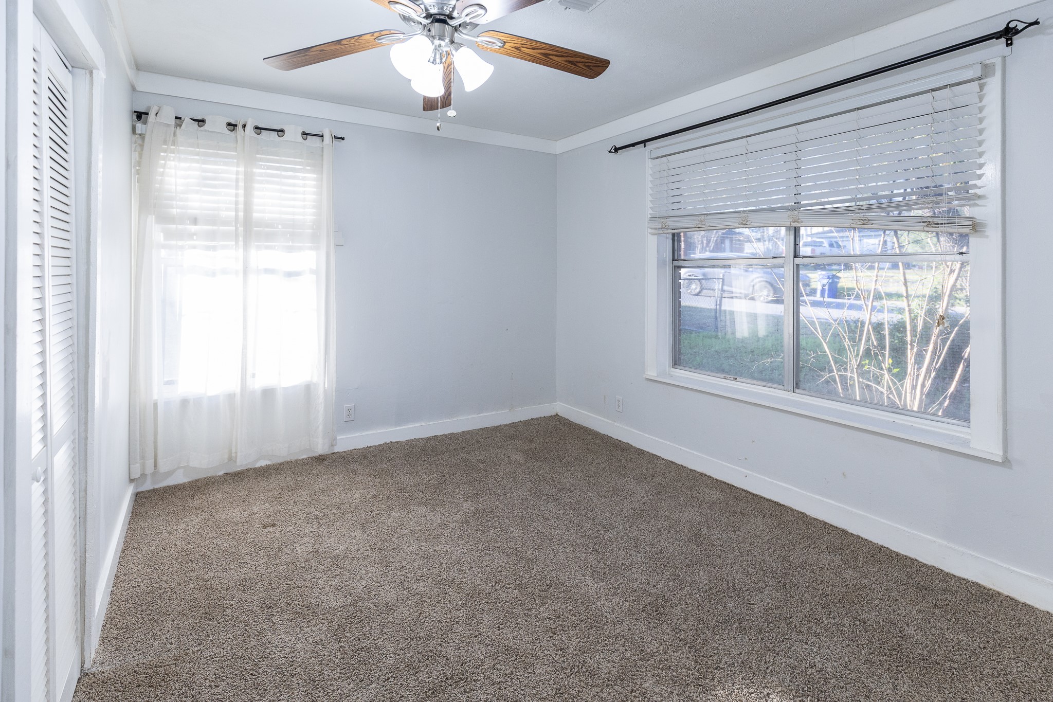 1425 15th Street Huntsville, TX 77340 - Photo 13 of 50 an empty room with a window and a fan