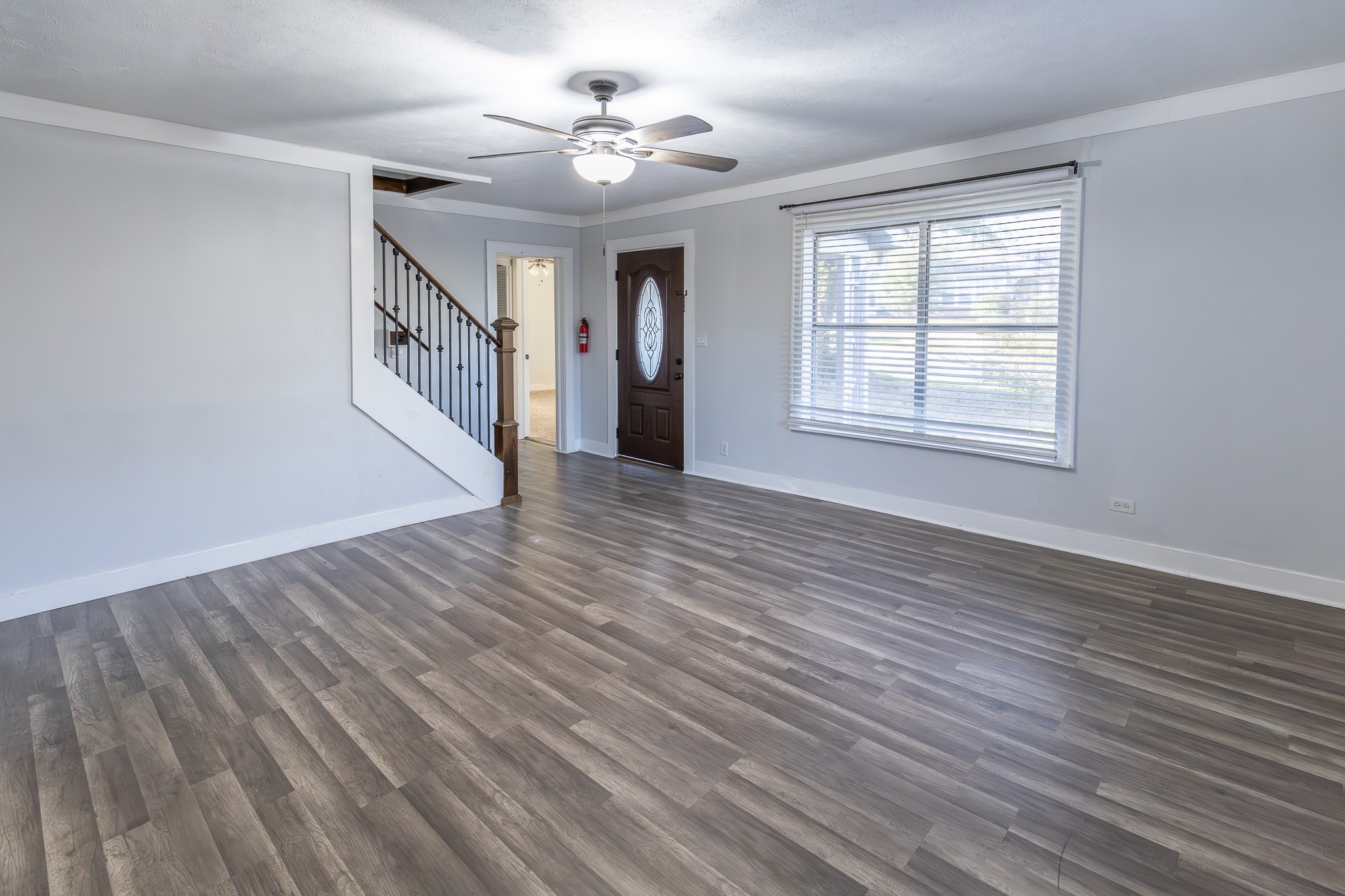 1425 15th Street Huntsville, TX 77340 - Photo 16 of 50 a view of an empty room with wooden floor and a window