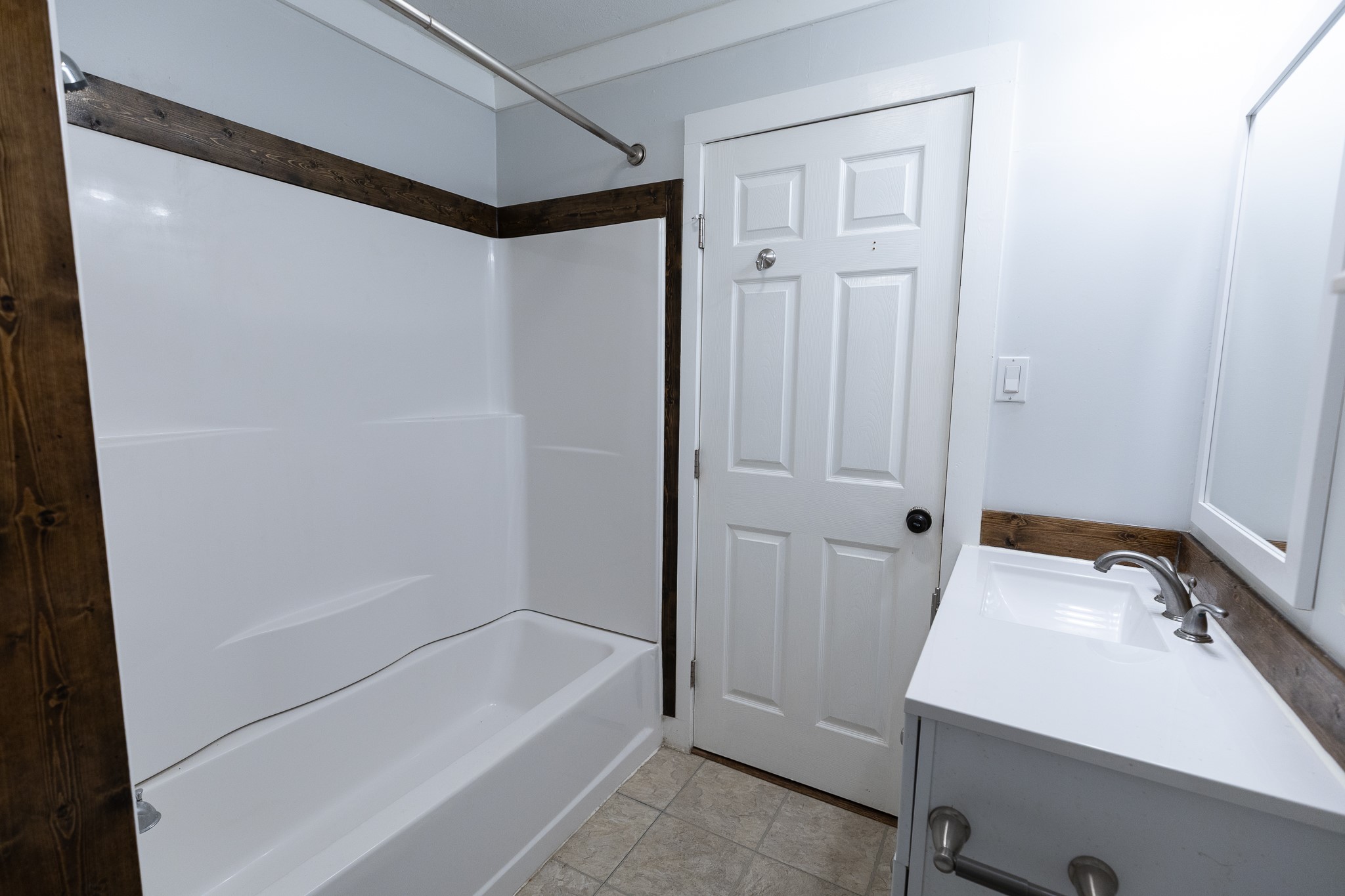 1425 15th Street Huntsville, TX 77340 - Photo 28 of 50 a bathroom with a bathtub and a shower