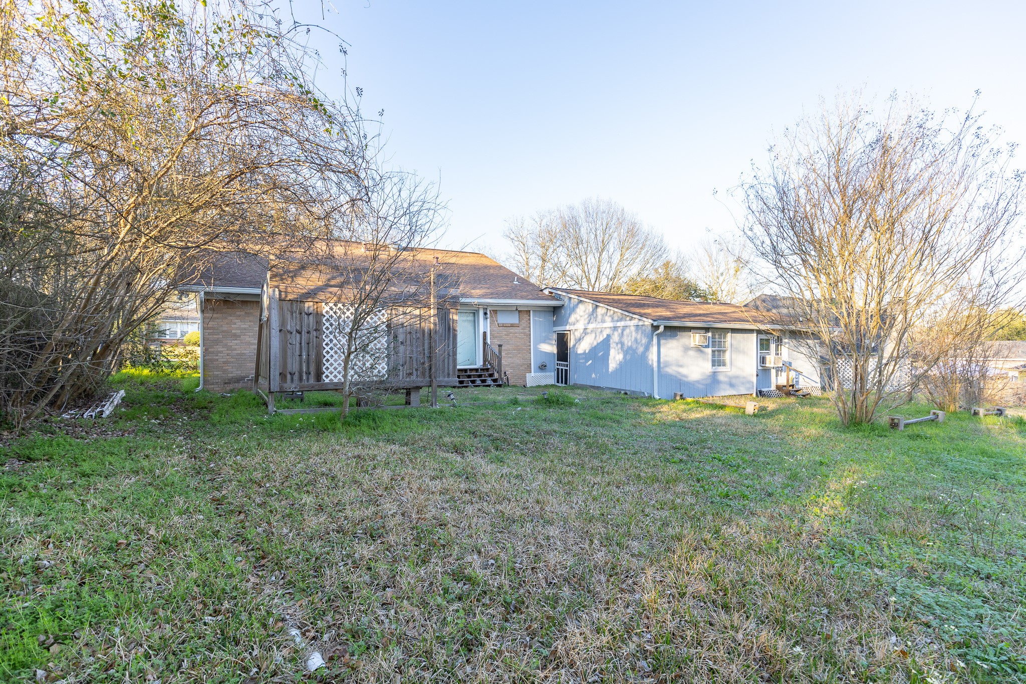 1425 15th Street Huntsville, TX 77340 - Photo 39 of 50 a view of a yard in front of a house with large trees
