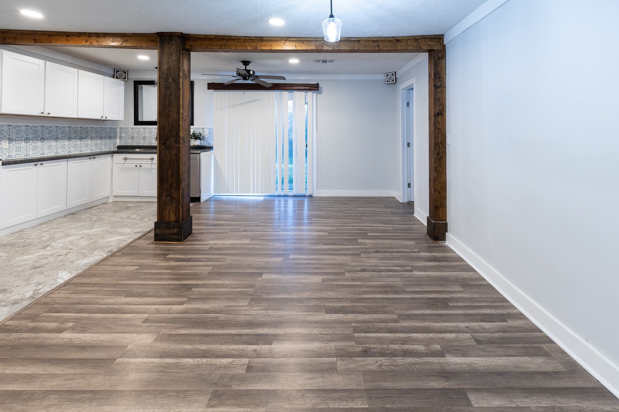 1425 15th Street Huntsville, TX 77340 - Photo 10 of 50 a view of a hallway with wooden floor and a kitchen