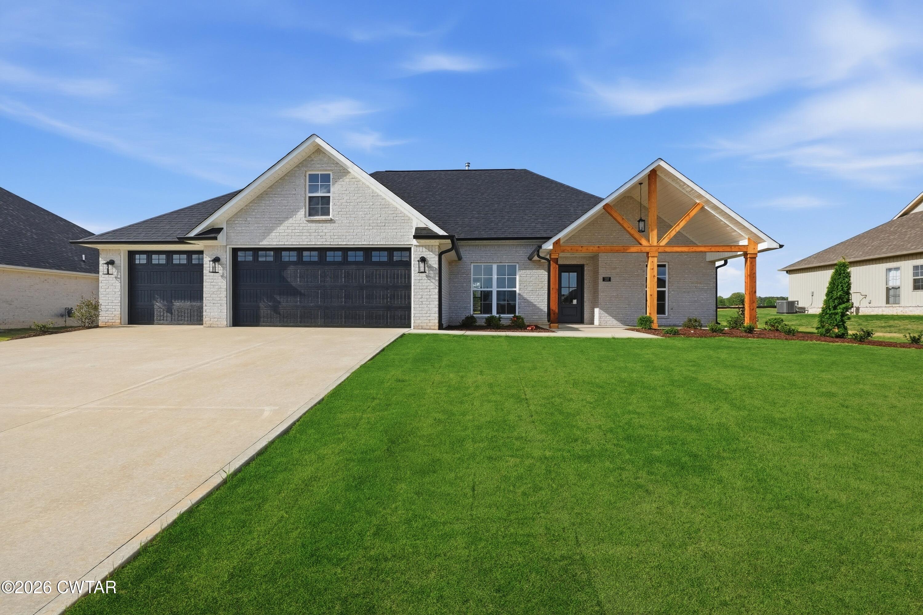 a front view of house with yard and green space