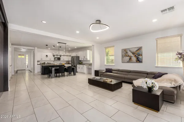 a kitchen with stainless steel appliances granite countertop a stove a sink a dining table and chairs