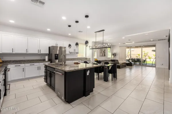 a kitchen with stainless steel appliances granite countertop a sink stove and microwave