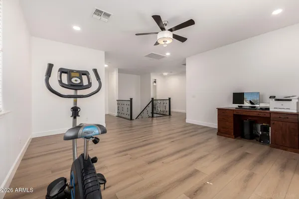 a bedroom with a bed and a ceiling fan