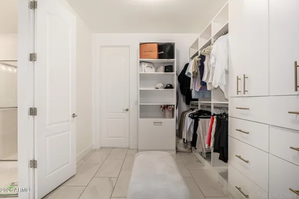 a bedroom with a bed and a large mirror