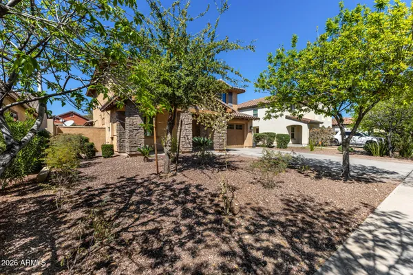 a front view of a house with a tree