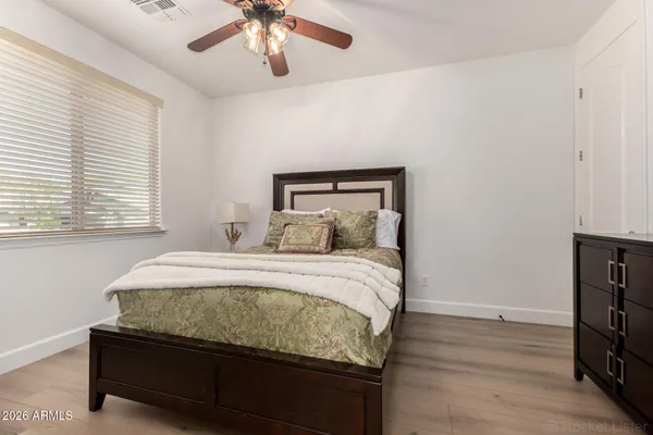 a bedroom with a bed and a chandelier