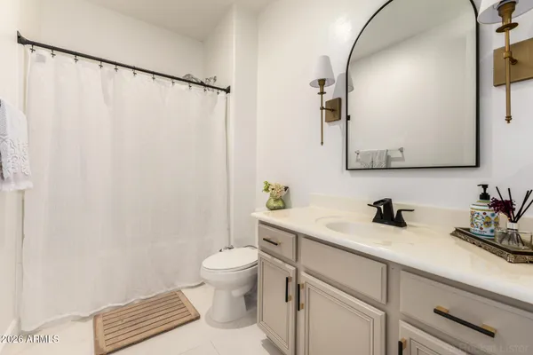 a white toilet sitting next to a shower curtain