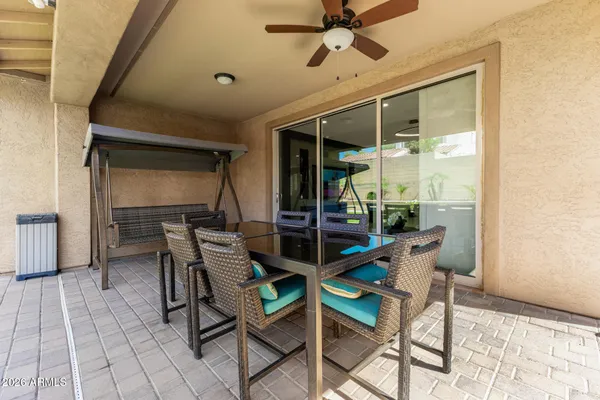 a view of a house with backyard porch and sitting area