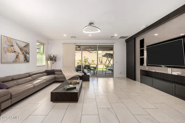 a living room with a fireplace and a walk in closet