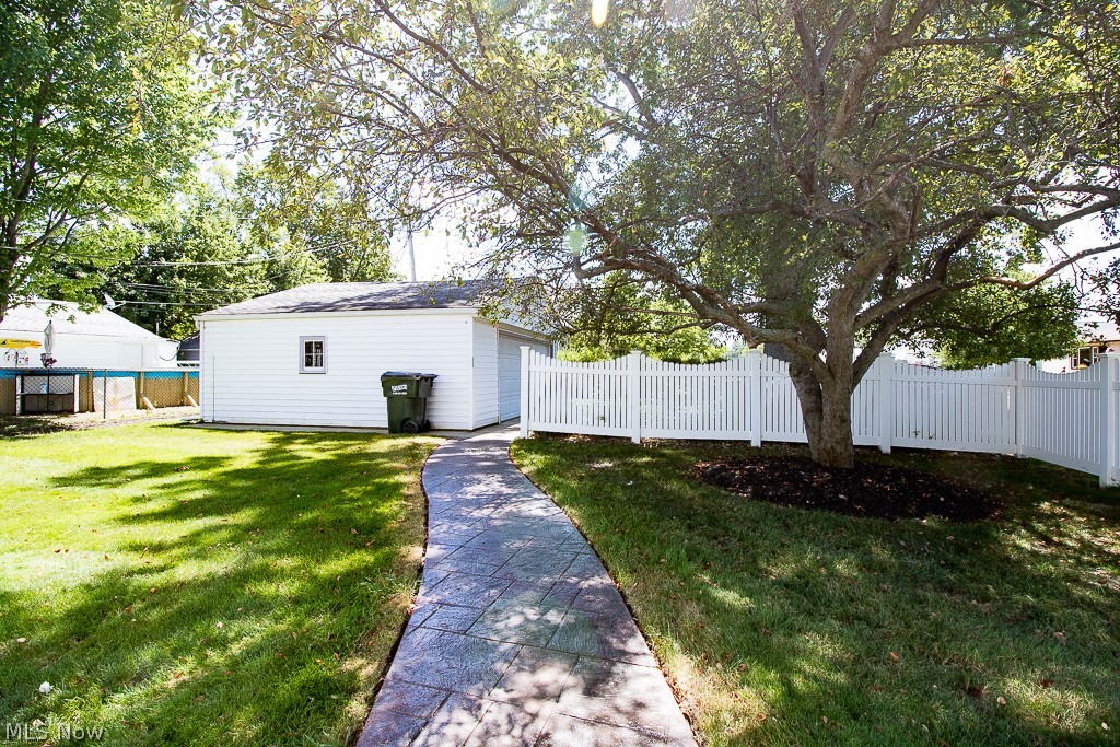 31654 Densmore Road Willowick, OH 44095 - Photo 4 of 25 The corner lot has ample space to entertain in the yard and a vinyl privacy fence that runs along the stamped concrete patio