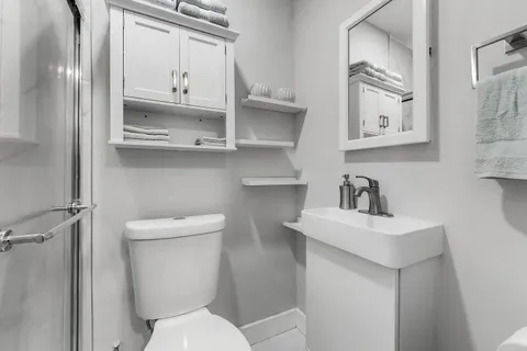 a white toilet sitting next to a bathroom sink