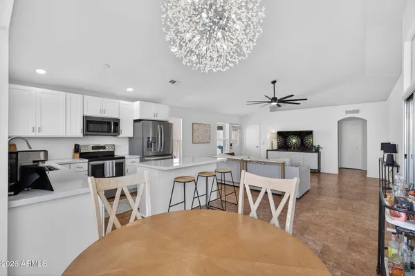 a living room with stainless steel appliances kitchen island granite countertop furniture and a kitchen view