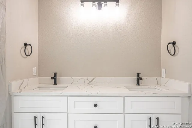 a bathroom with a sink and vanity