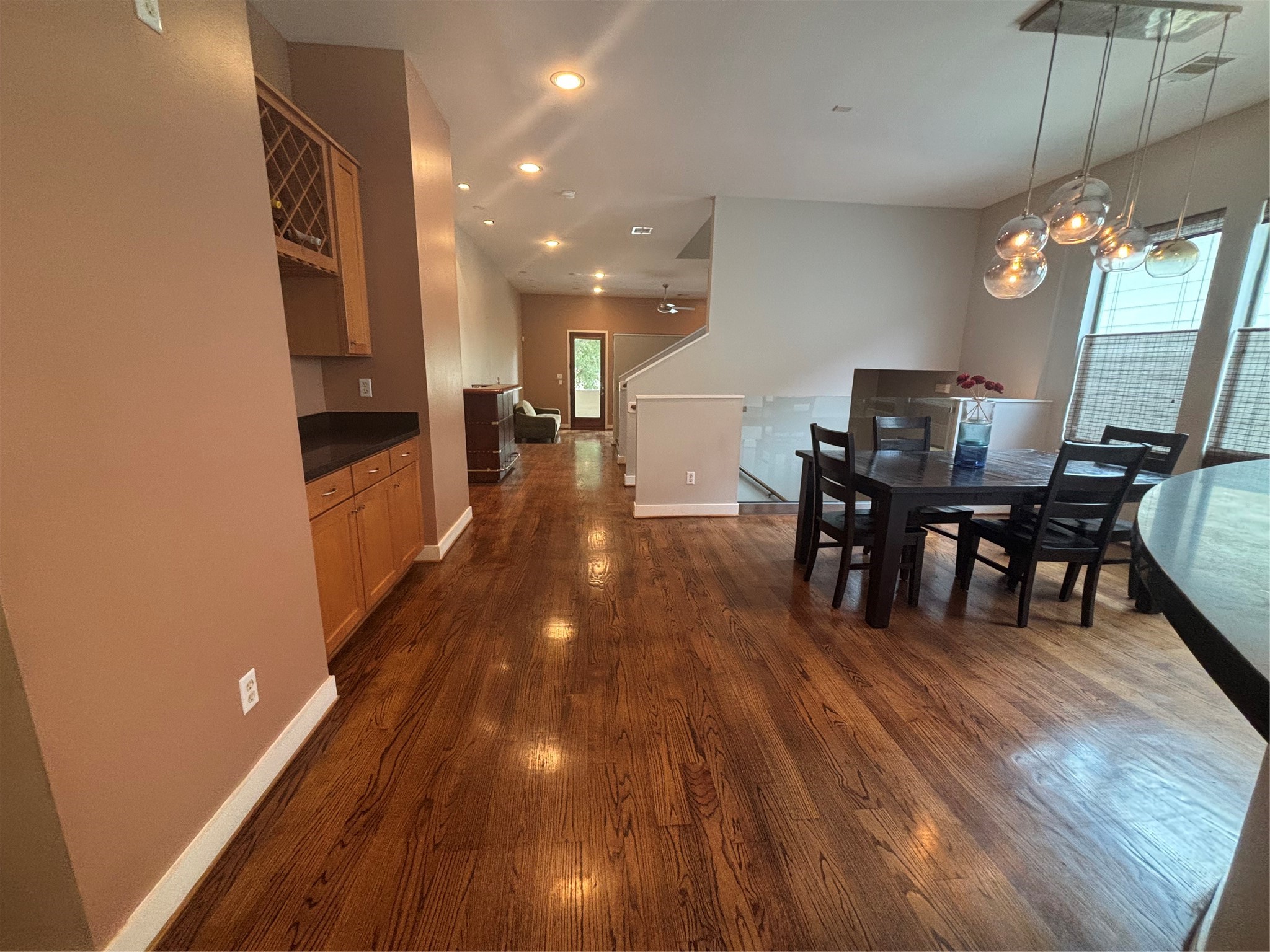 6016 Truro Street Houston, TX 77007 - Photo 3 of 26 Open dining and entertaining area with gleaming hardwoods, stylish pendant lighting, and convenient built-in wine storage.