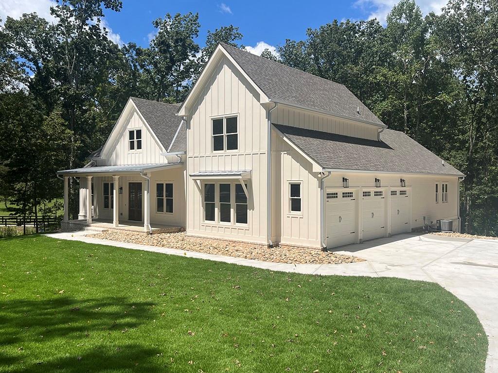 2226 Upper Burris Road Ball Ground, GA 30107 - Photo 1 of 65 a front view of a house with a yard