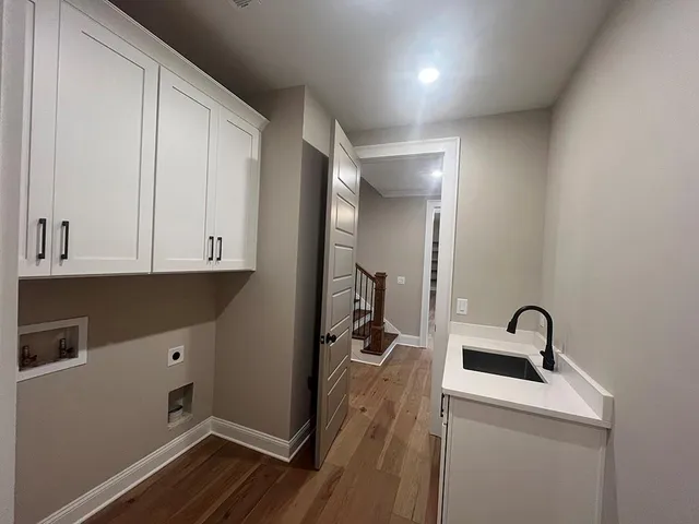 a view of a livingroom with wooden floor and a ceiling fan