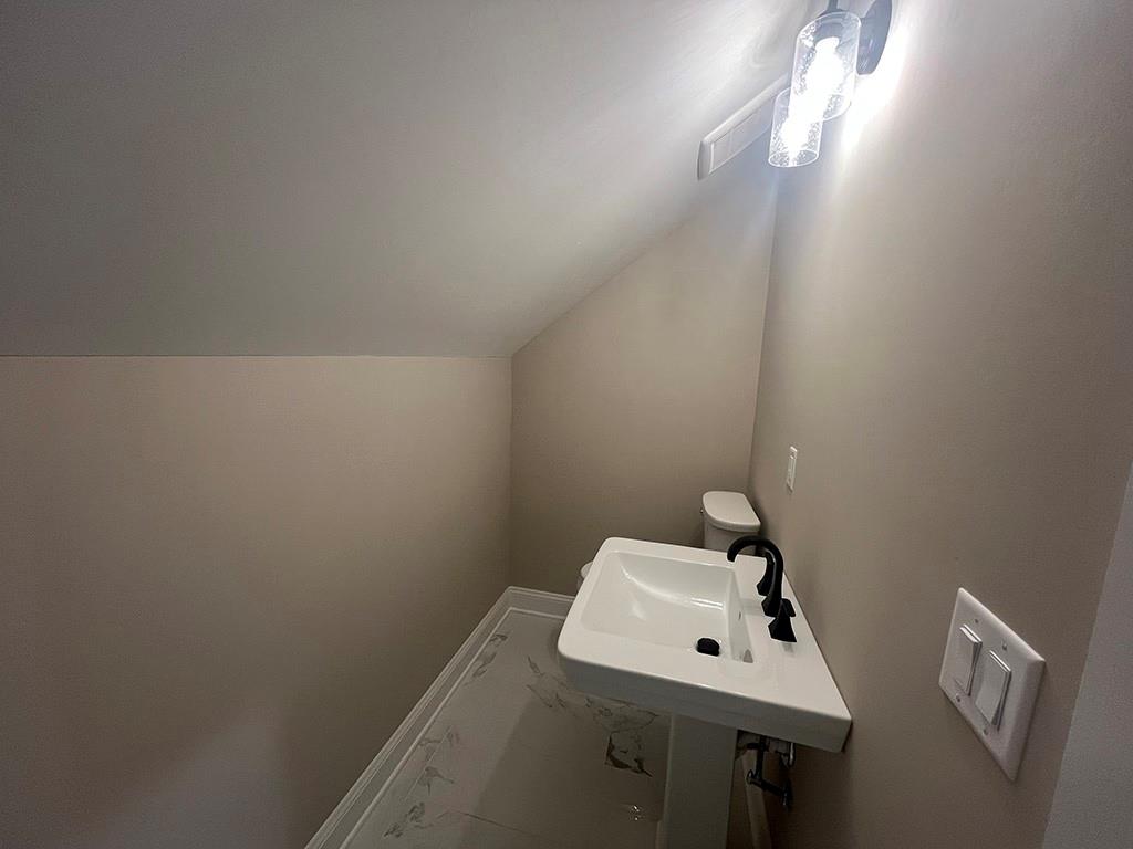 2226 Upper Burris Road Ball Ground, GA 30107 - Photo 23 of 65 a bathroom with a sink mirror and toilet