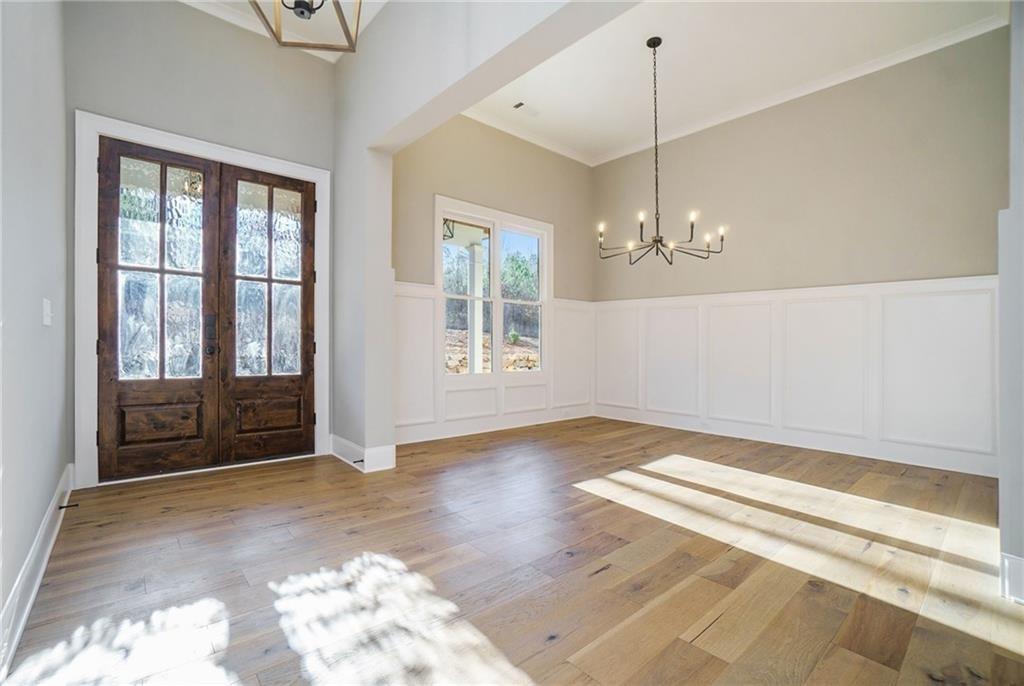 2226 Upper Burris Road Ball Ground, GA 30107 - Photo 32 of 65 a view of a livingroom with wooden floor and a ceiling fan