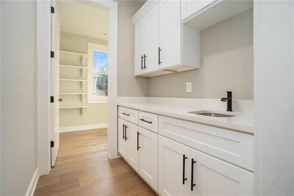 2226 Upper Burris Road Ball Ground, GA 30107 - Photo 42 of 65 a kitchen with white cabinets and sink