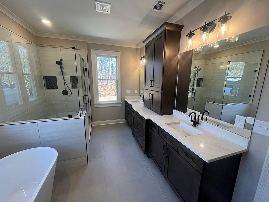 2226 Upper Burris Road Ball Ground, GA 30107 - Photo 50 of 65 a bathroom with a sink double vanity granite tub shower and a mirror