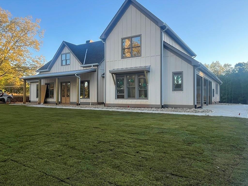 2226 Upper Burris Road Ball Ground, GA 30107 - Photo 5 of 65 a front view of a house with a garden