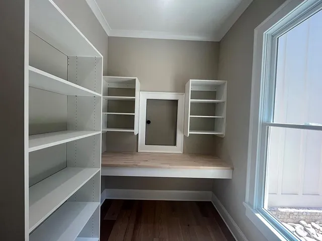a view of an empty room with a fireplace and a window
