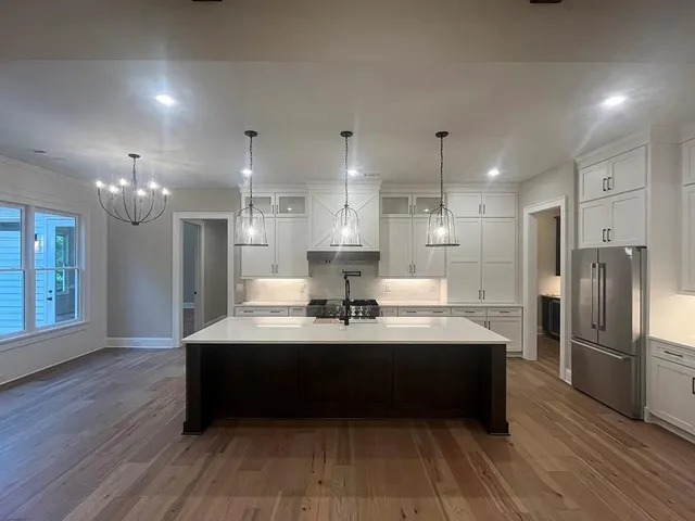 a view of empty room with wooden floor and fireplace