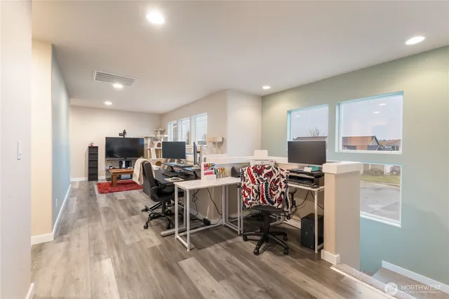 a view of a workspace with furniture and a window