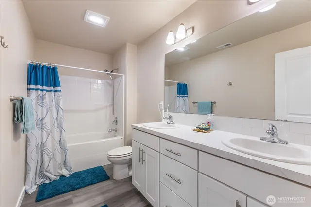 a spacious bathroom with a sink a toilet and shower