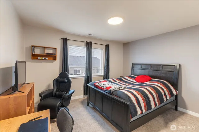 a bedroom with a bed and a desk