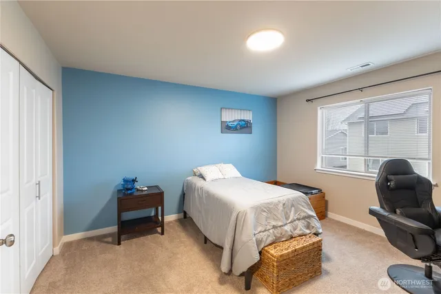 a bedroom with a bed and a chair