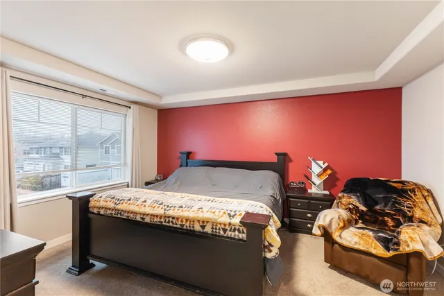 a bed sitting in a room next to a window