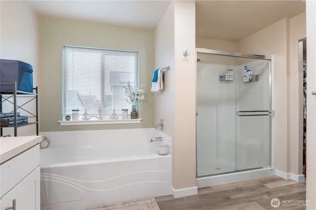 a bathroom with a bathtub and a shower