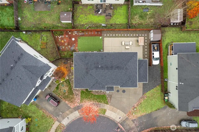 an aerial view of a house with a yard