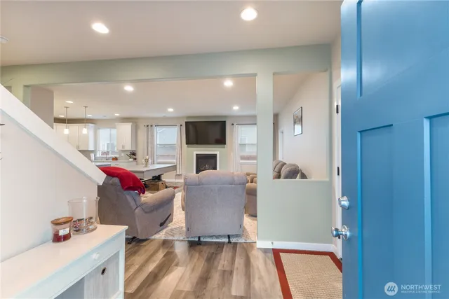 a living room with furniture and kitchen view