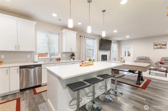 a large white kitchen with lots of counter space sink and appliances