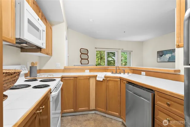 a kitchen with a refrigerator and a sink
