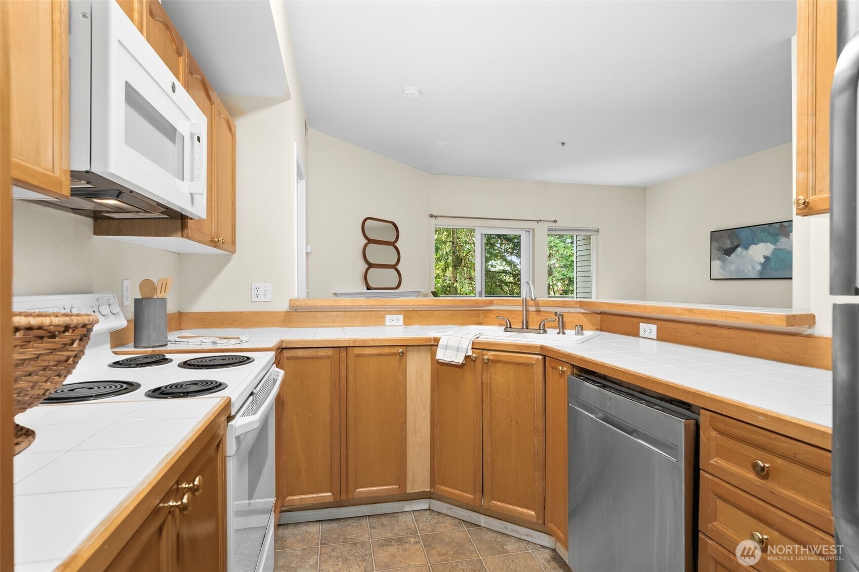 12120 Northeast 172nd Place, Unit L201 Bothell, WA 98011 - Photo 11 of 35 a kitchen with a sink stove and cabinets