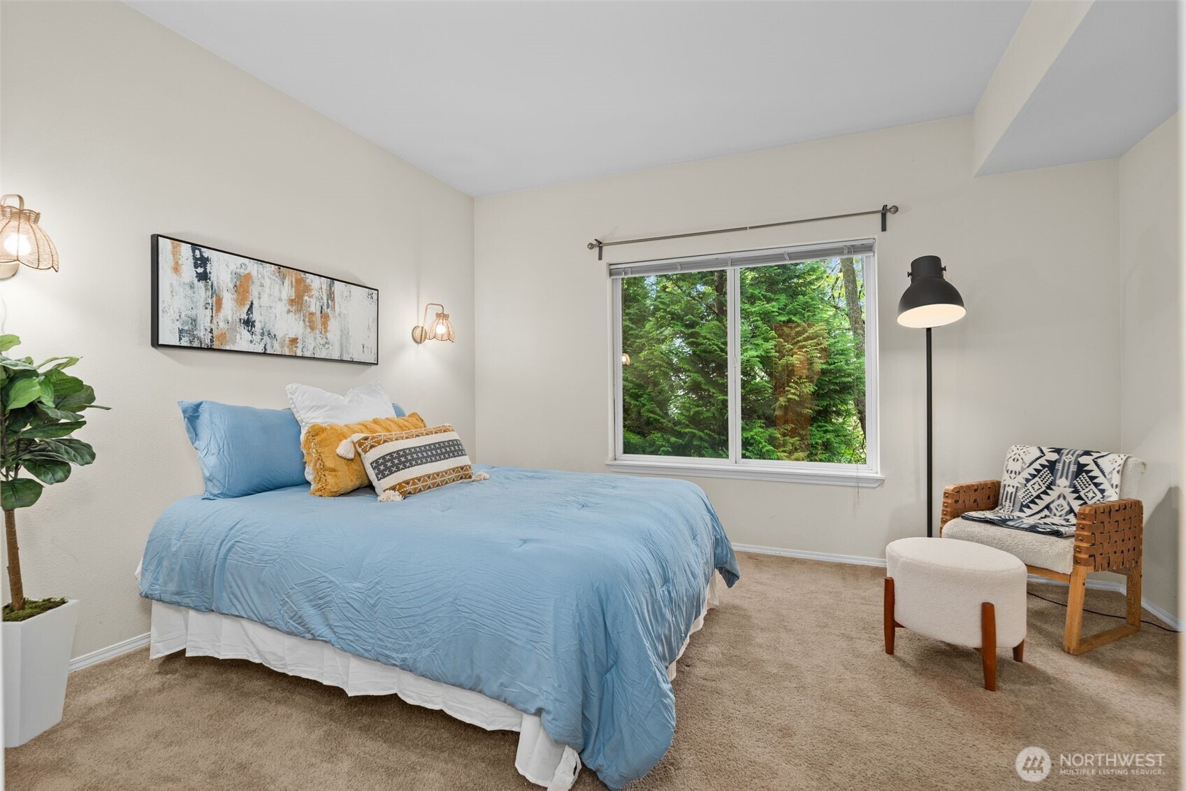 12120 Northeast 172nd Place, Unit L201 Bothell, WA 98011 - Photo 14 of 35 a bedroom with a bed and a large window