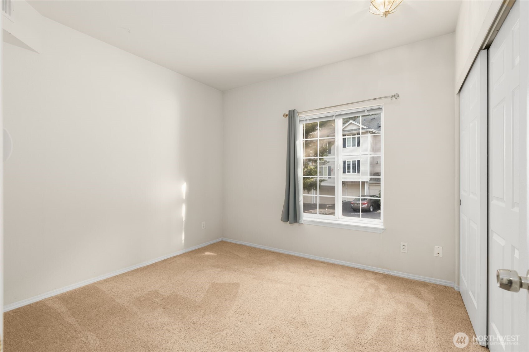 12120 Northeast 172nd Place, Unit L201 Bothell, WA 98011 - Photo 19 of 35 an empty room with a window