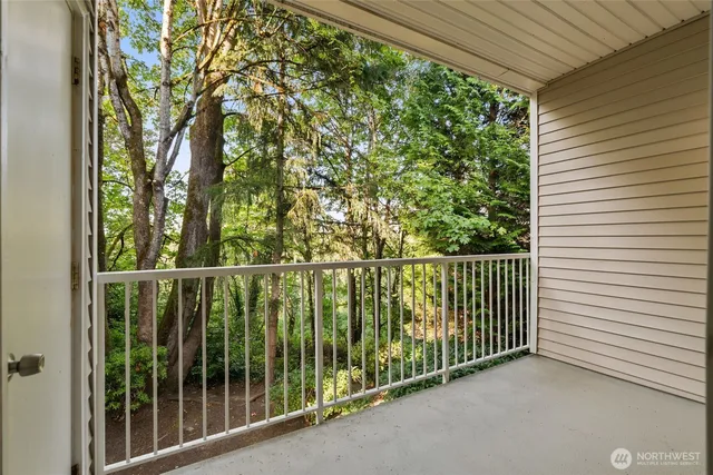 a view of a balcony with trees