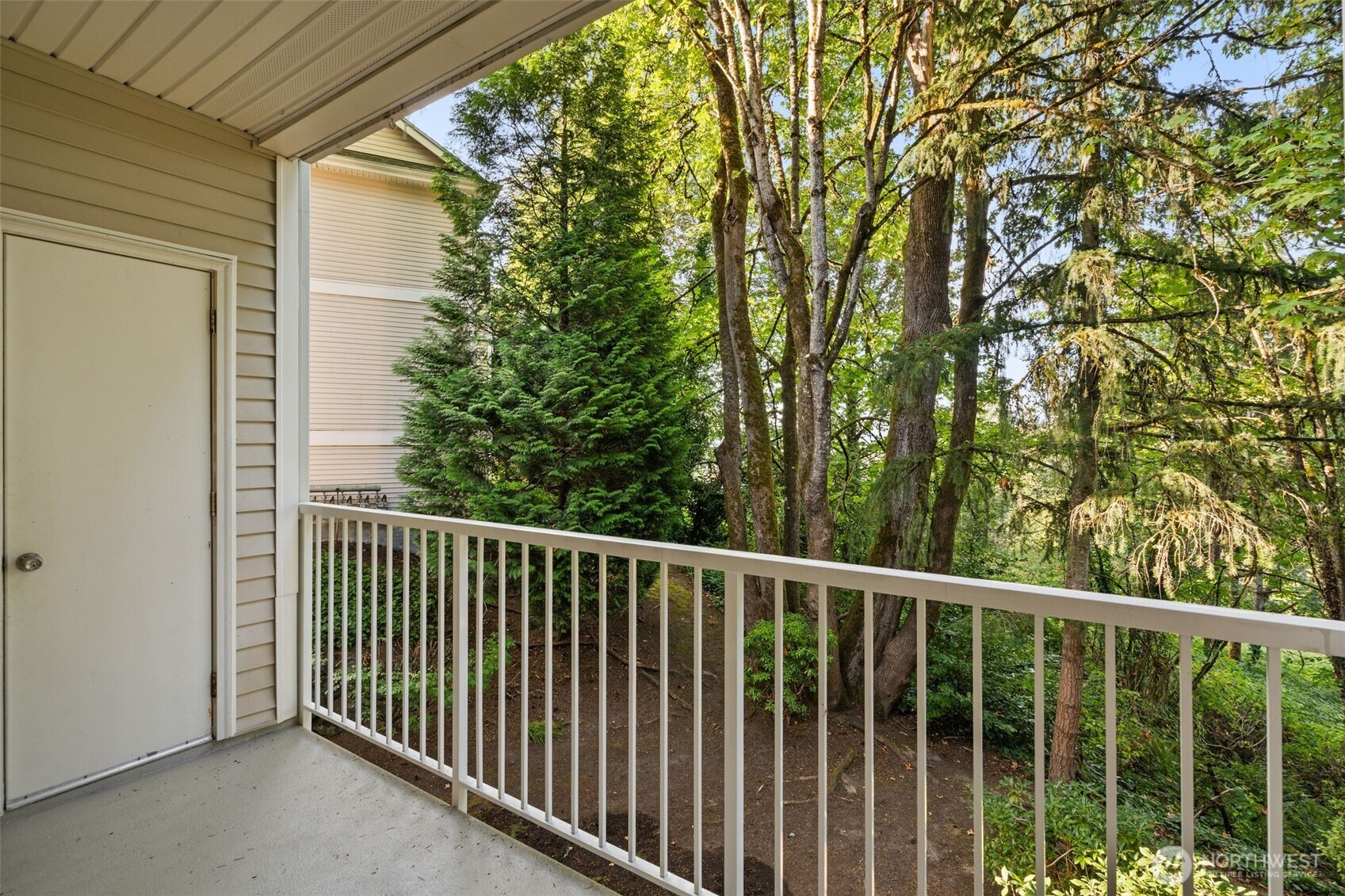 12120 Northeast 172nd Place, Unit L201 Bothell, WA 98011 - Photo 22 of 35 a view of a balcony with trees